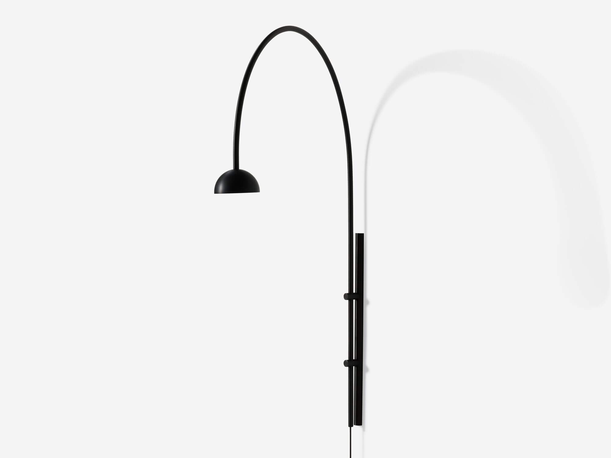 Front angle view of large black arched wall lamp